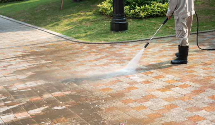 Cleaning sidewalk using pressure washing