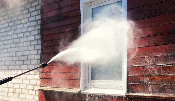 Cleaning a window using soft washing techniques