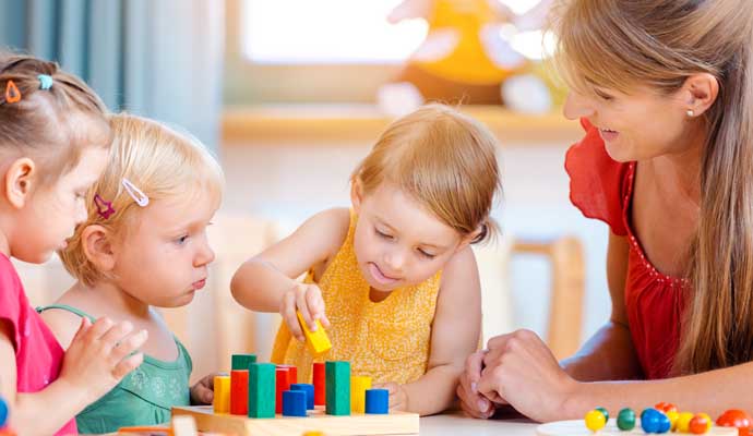 children playing with colorful wooden didactic toys 