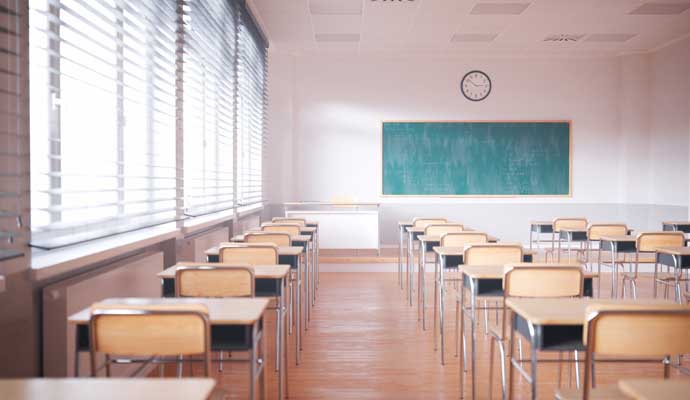  clean classroom floor with chairs, light wooden desks, 