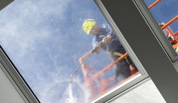 Cleaning window of a hotel using pressure washing