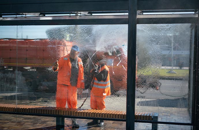 professional worker cleaning commercial window