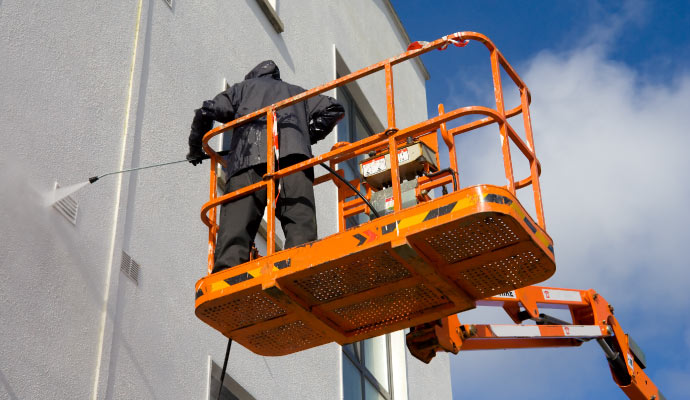 Pressure washing the exterior of an apartment building