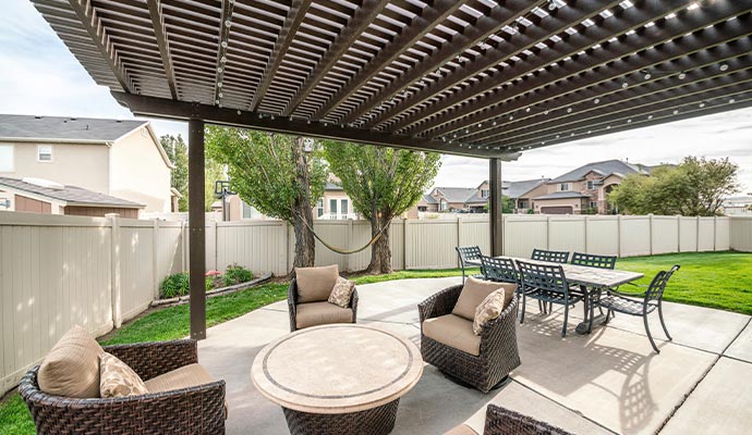 A clean and bright pergola with outdoor furniture.