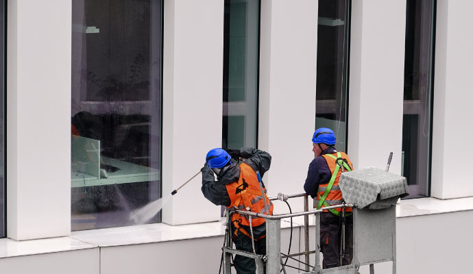 Soft washing the outdoor glass of a commercial building