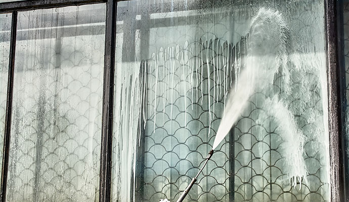 A window being cleaned with a soft washer