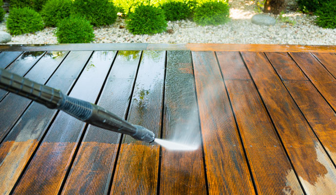 Pressure washing a wooden deck for deep cleaning